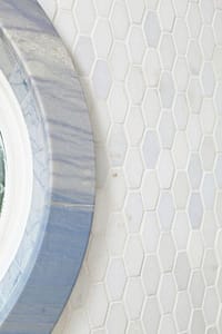 Shower with white tile and blue window