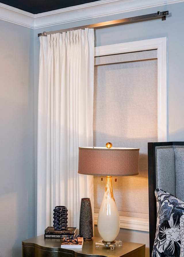 bed in middle of two windows and curtains off to one side window curtains on one side of a window bed in middle
