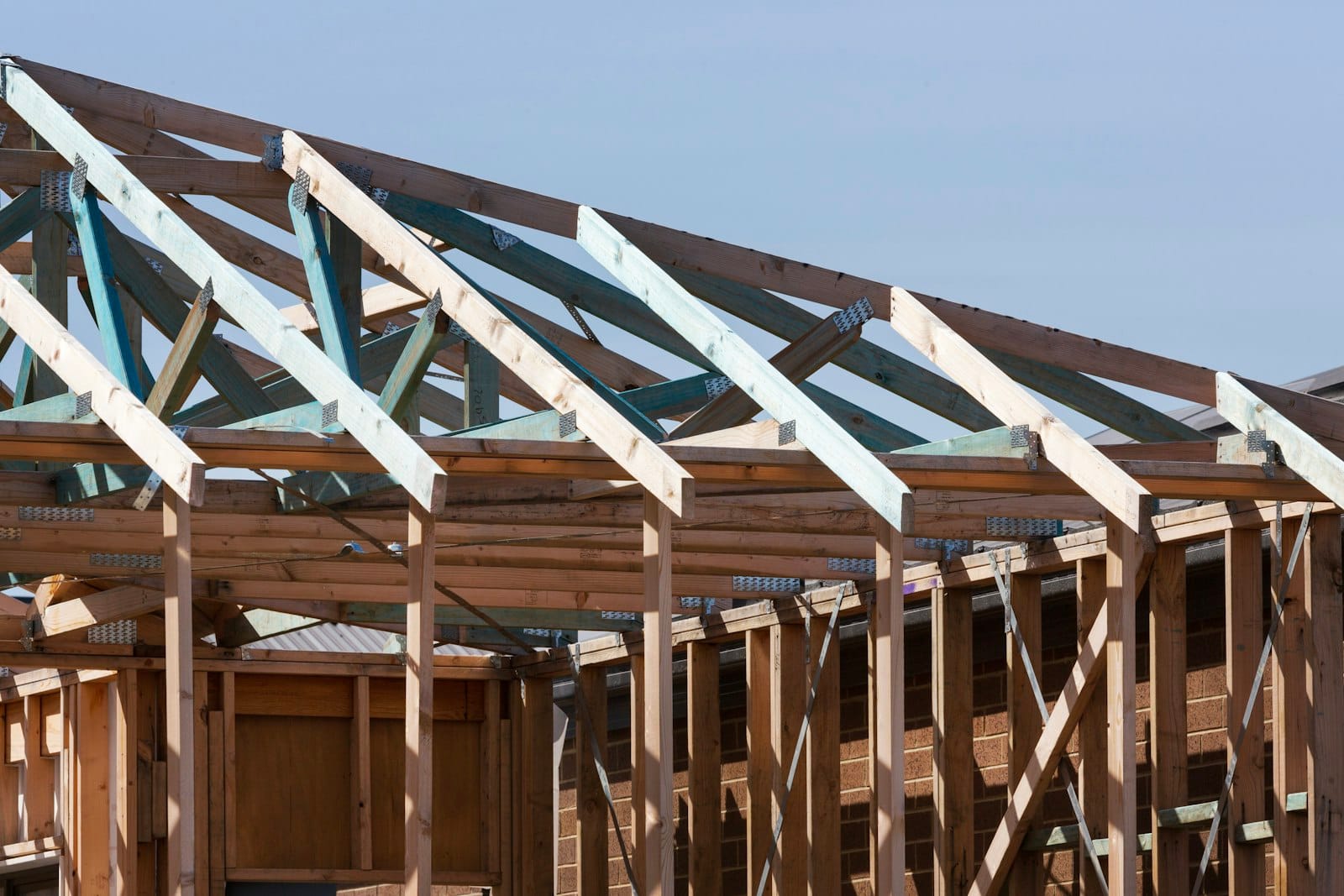 New wood roof framing of a home addition being built onto an existing house, the kind of project this guide to planning a home addition in Kitsap County, WA covers