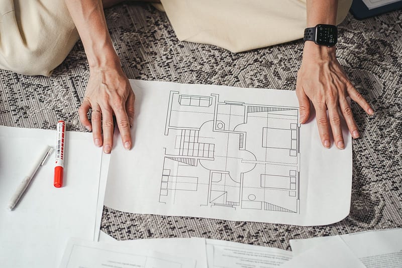 hands reviewing architectural floor plan home design Poulsbo WA